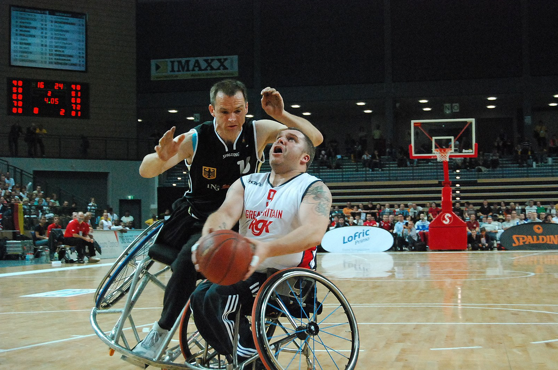 personas con discapacidad física jugando a baloncesto en silla de ruedas